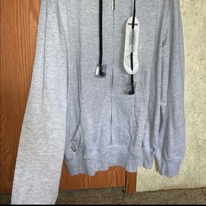 A large gray hoodie with headphones built into it.